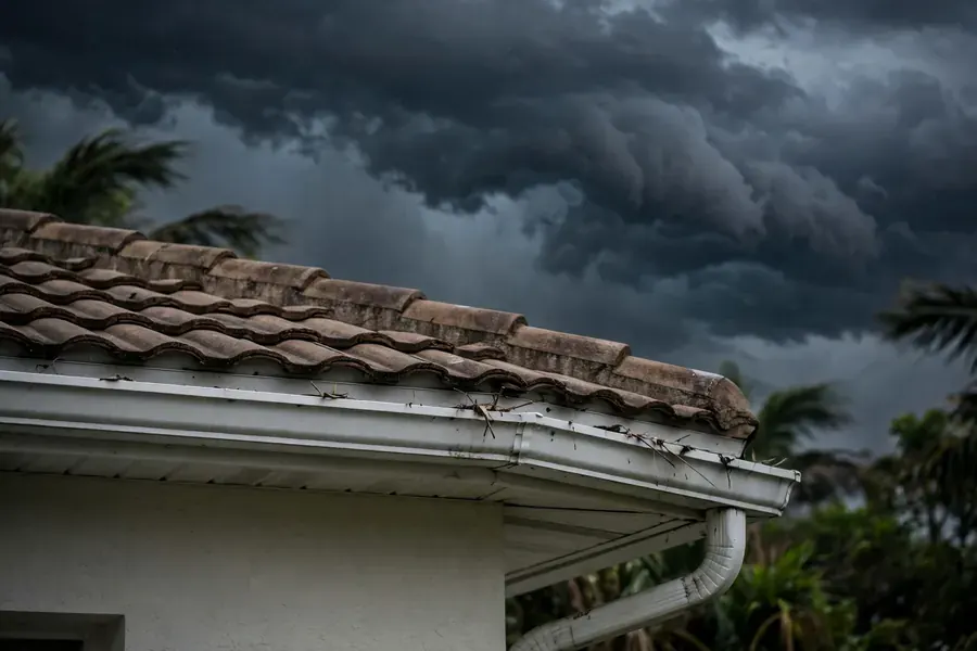 Dark storm clouds gathering over a Florida roofline before hurricane season, Fort Pierce, FL